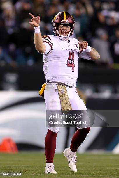 Taylor Heinicke of the Washington Commanders celebrates after an unnecessary roughness penalty was called against the Philadelphia Eagles during the...