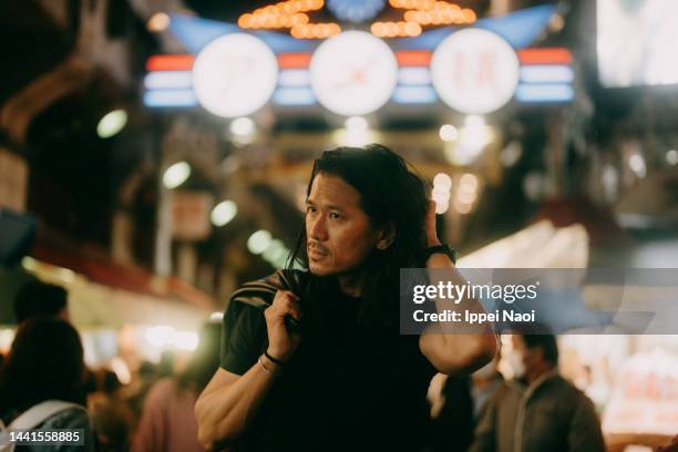 man walking in tokyo night market - night market stock pictures, royalty-free photos & images