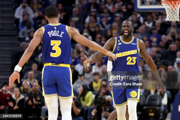 Draymond Green of the Golden State Warriors congratulates Jordan Poole after he made a basket against the San Antonio Spurs at Chase Center on...