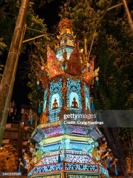 pattaya loi krathong thai chinese style lanterns of many colours on display in temple. colourful illuminations for ancient style lamps shine across the street. establishing shot of south east asia tourist area with arts and crafts - pattaya stock pictures, royalty-free photos & images