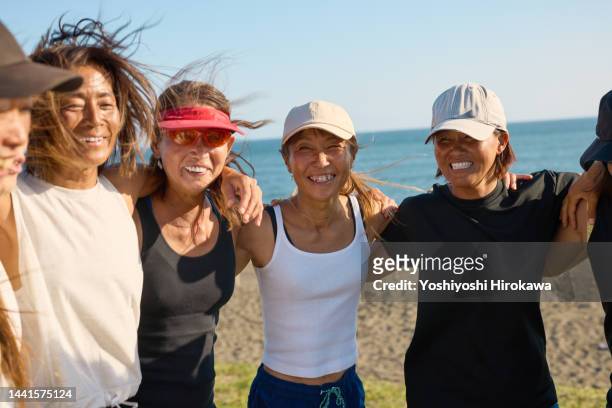 portrait of senior women smiling for the camera - portrait of a woman 40 50 summer stock pictures, royalty-free photos & images