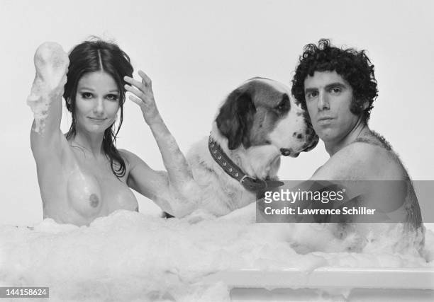 In a a promotional portrait for their film 'Move,' American actors Paula Prentiss and Elliott Gould, along with a dog, pose in a bubble bath, Los...