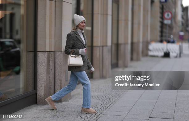 Mandy Bork wearing Agolde blue jeans, Viky Rader Studio beige knit turtleneck sweater, Nakd checked tweed blazer, Hermes beige leather Kelly bag, Ugg...