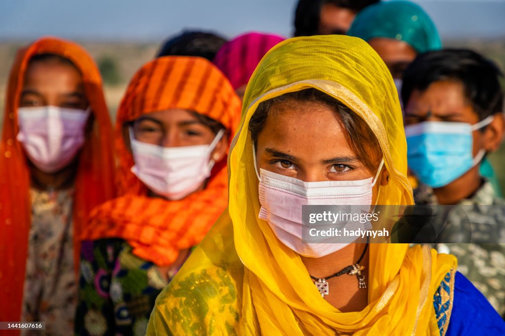 Group of Indian children wearing face masks, desert village, India