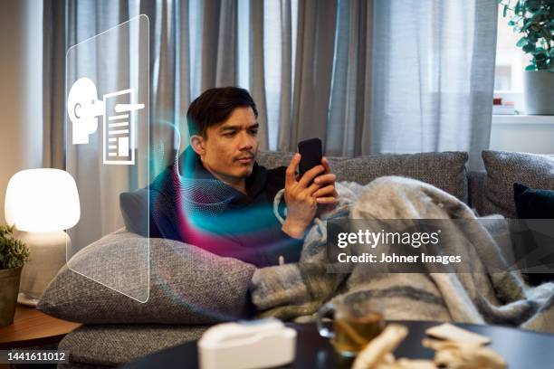 man reading fake news on cell phone - fake news stock-fotos und bilder