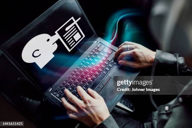 man reading fake news on laptop - fake news media stock pictures, royalty-free photos & images