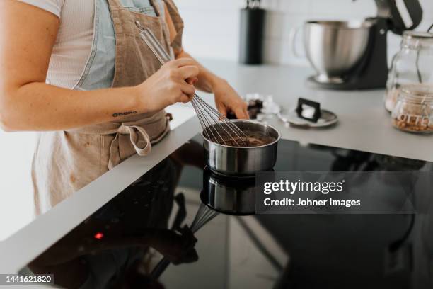 woman in kitchen preparing food - electric stove burner stock pictures, royalty-free photos & images