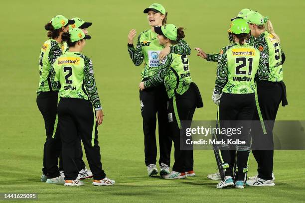 Amy Jones of the Thunder celebrates with her team after taking the catch for the wicket of Josephine Dooley of the Renegades during the Women's Big...