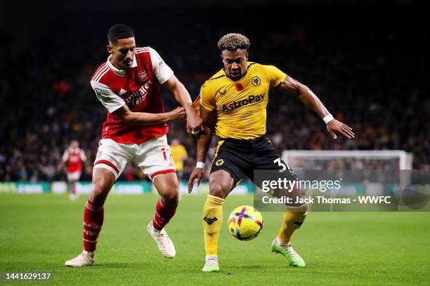 Adama Traore of Wolverhampton Wanderers is challenged by William Saliba of Arsenal during the Premier League match between Wolverhampton Wanderers...