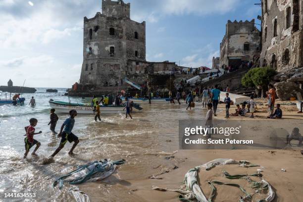 Somali children swim and play at the old port and traditional lighthouse, as famine looms over Somalia with an estimated 7.8 million people affected...