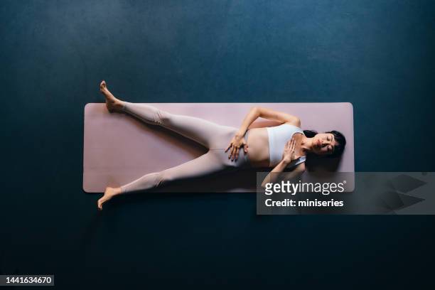 high angle view of beautiful woman doing breathing exercise - savasana stock pictures, royalty-free photos & images