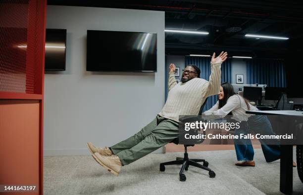 comical image of the late night antics of two misbehaving office workers - interview funny stockfoto's en -beelden