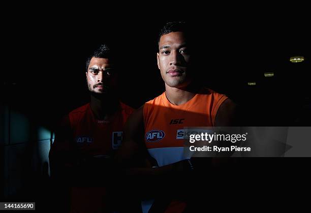 Karmichael Hunt of the Suns and Israel Folau of the Giants pose ahead of tomorrow's first AFL match between the Greater Western Sydney Giants and the...