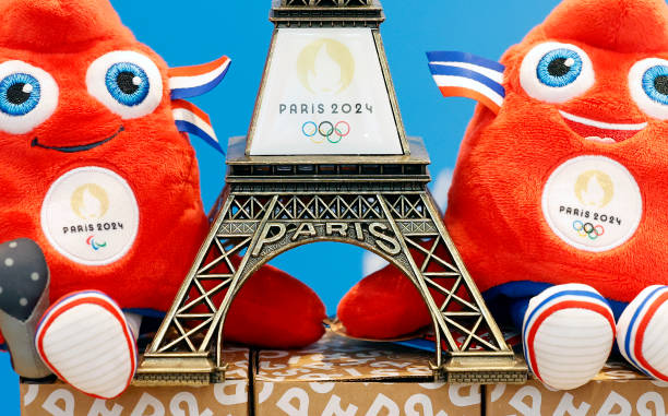 Replica of the Eiffel Tower with the logo of the 2024 Olympic Games surrounded by official mascots for the Paris 2024 Summer Olympic and Paralympic...