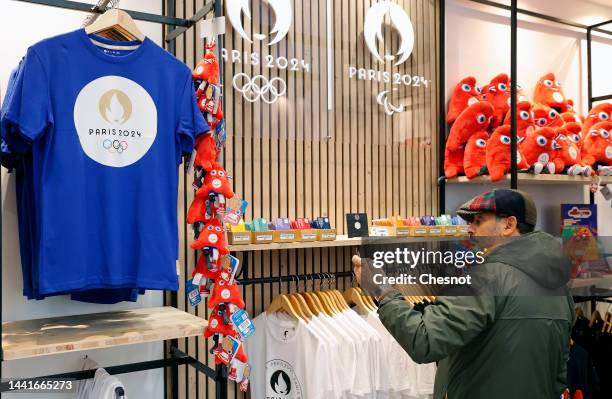 Customer looks at official mascot and tee shirts for the Paris 2024 Summer Olympic and Paralympic Games inside the official store entirely dedicated...