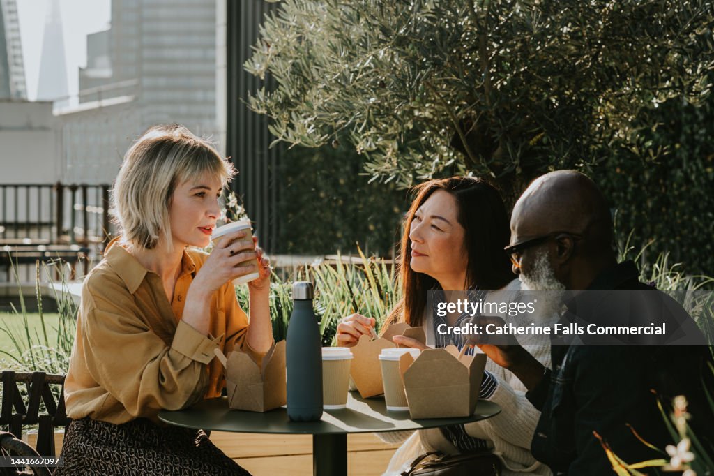 A group of coworkers enjoy an alfresco lunch