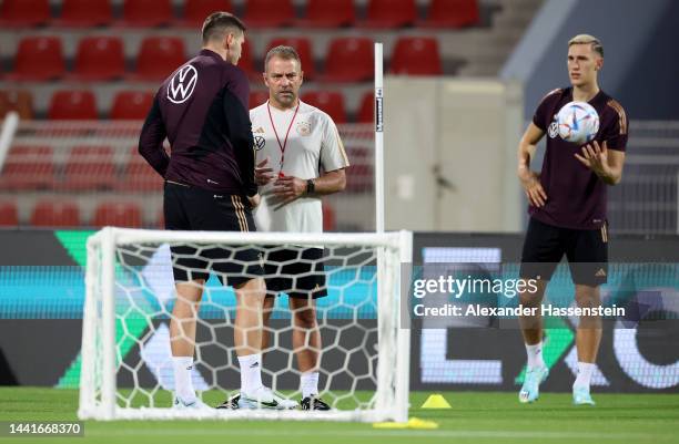 Head coach Hansi Flick talks to Niklas Süle during the Germany training session at Sultan Qaboos Sports Complex on November 15, 2022 in Muscat, Oman.