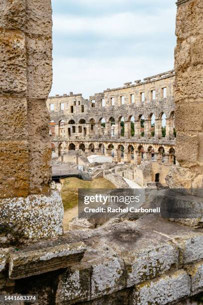 restored arched walls and interior of pula arena (roman amphitheatre). - pula stock-fotos und bilder