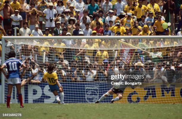 Brazilian footballer Zico fires his penalty past French goalkeeper Joel Bats during their quarter final match of the 1986 FIFA World Cup, held at the...