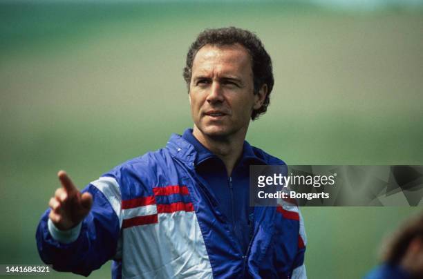 German football manager and former footballer Franz Beckenbauer, manager of the West Germany national team, wearing a red, white and blue tracksuit...