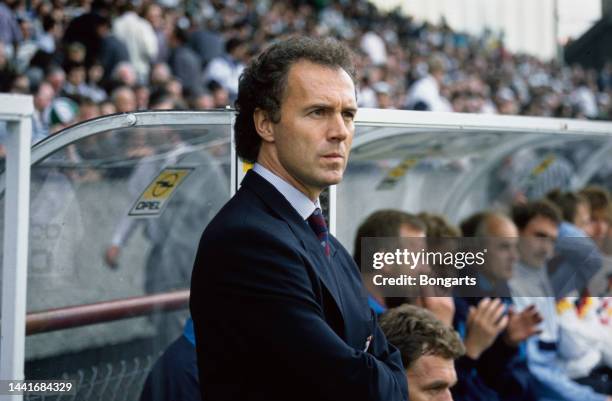 German football manager and former footballer Franz Beckenbauer, manager of the West Germany national team, his hands in his pockets, wearing a dark...
