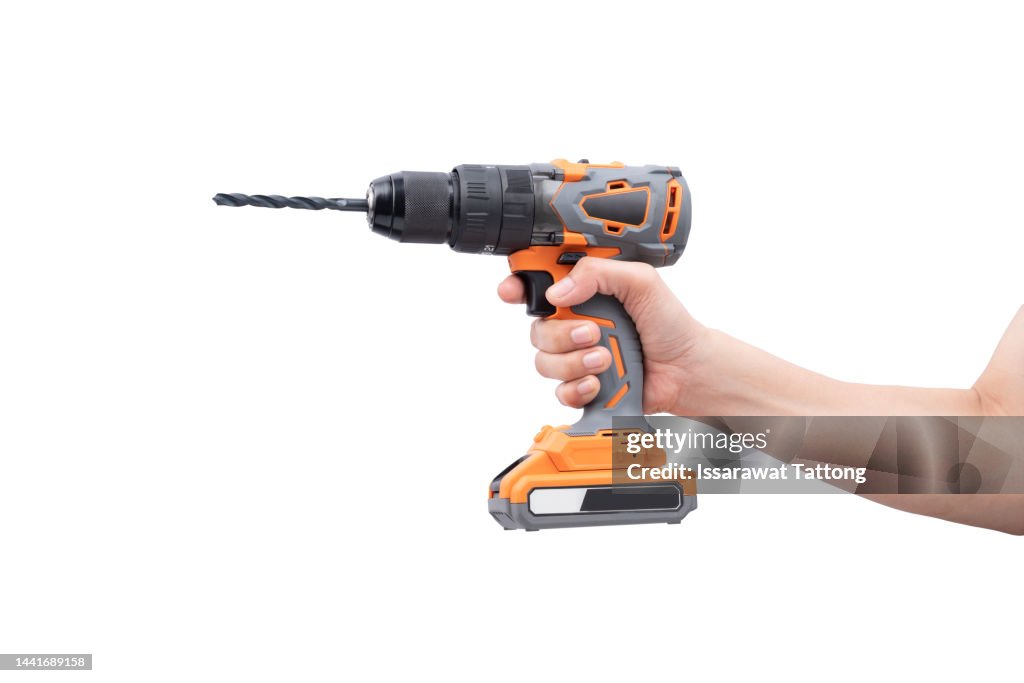 Battery screwdriver or drill on hand, isolated on white background