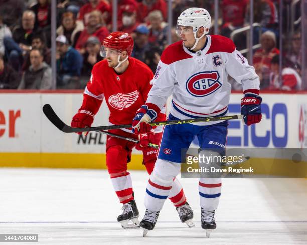 Nick Suzuki of the Montreal Canadiens skates up ice in front of Pius Suter of the Detroit Red Wings during the third period of an NHL game at Little...