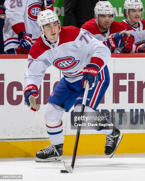 Kirby Dach of the Montreal Canadiens skates up ice with the puck against the Detroit Red Wings during the O.T. Period of an NHL game at Little...