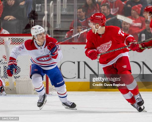 Adam Erne of the Detroit Red Wings looks back at Cole Caufield of the Montreal Canadiens during the third period of an NHL game at Little Caesars...