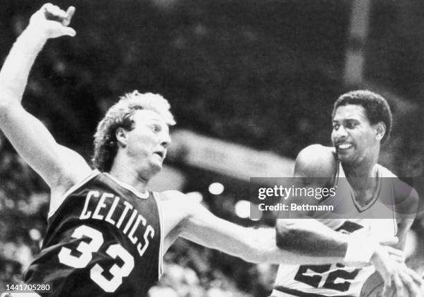 John Drew of the Utah Jazz strips the ball away from Celtics' Larry Bird .