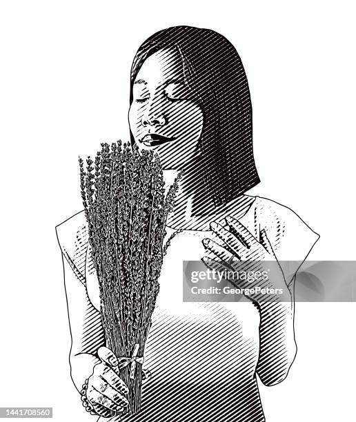 woman smelling lavender flowers - achtsamkeit persönlichkeitseigenschaft stock-grafiken, -clipart, -cartoons und -symbole
