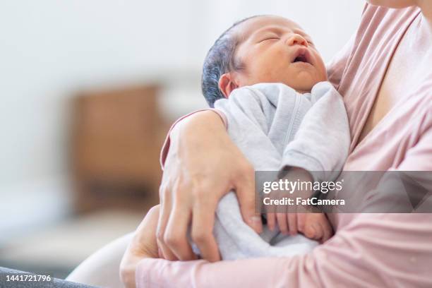 Mother Rocking Mother Rocking Baby To Sleep Photos and Premium High Res Pictures ...