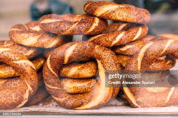 stacks of turkish bagels or simits with sesame seeds for sale, istanbul, turkey - turkish bagel stock pictures, royalty-free photos & images