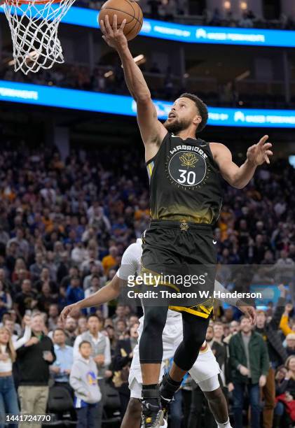 Stephen Curry of the Golden State Warriors goes in for a layup against the Cleveland Cavaliers in the fourth quarter of an NBA basketball game at...