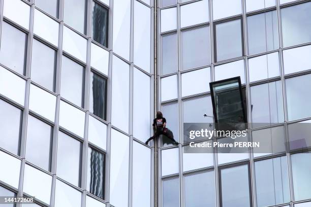 Alain Robert, known as the French 'Spiderman' climbs the 'First' tower, the highest building in France on May 10, 2012 in Paris La Defense, Hauts de...