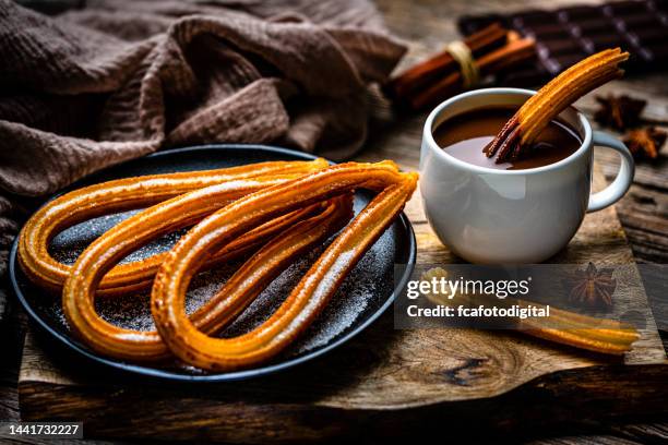 churros plate and hot chocolate mug - spanish food stock pictures, royalty-free photos & images