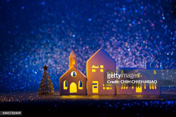 illuminated christmas tree at night - fairytale village stock pictures, royalty-free photos & images