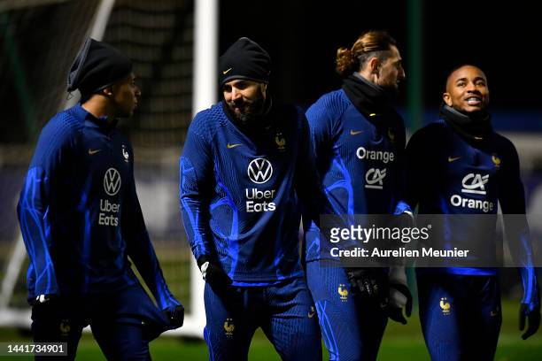 Kylian Mbappe, Karim Benzema, Adrien Rabiot and Christopher Nkunku speak during a Team France training session at Centre National du Football on...