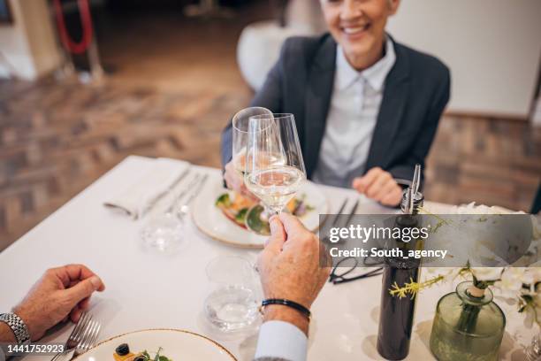 mature couple in restaurant - couple fine dining stock pictures, royalty-free photos & images