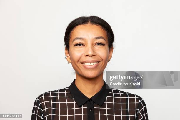 close up studio portrait of a cheerful middle aged african american woman in a plaid blouse against a white background - hair back stock pictures, royalty-free photos & images