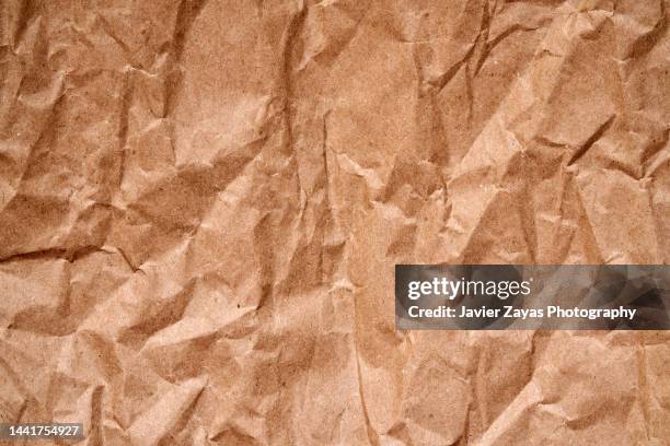 recycled brown crumpled paper - packpapier stock-fotos und bilder