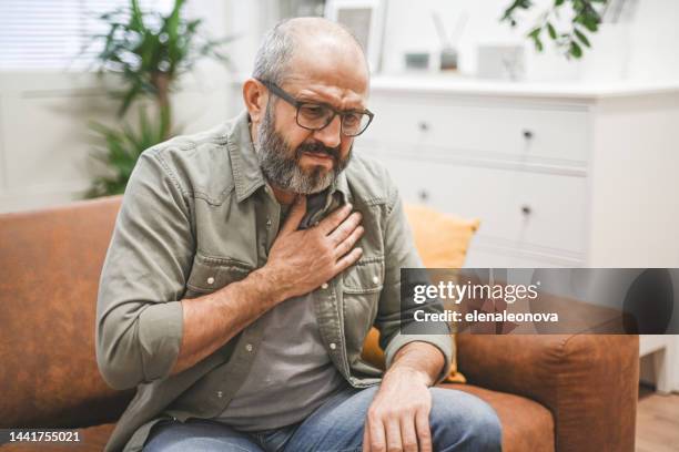 mature adult man illness - heartburn stock pictures, royalty-free photos & images