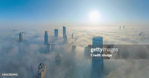 aerial view of advection fog above buildings in downtown wuxi - bridge building glass stock pictures, royalty-free photos & images