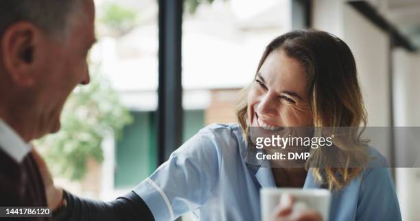 healthcare, retirement and man with nurse, coffee and happy nursing home together with smile. senior care, grandpa and woman caregiver or doctor spending time in retirement home, hospital or clinic. - senior men cafe stock pictures, royalty-free photos & images