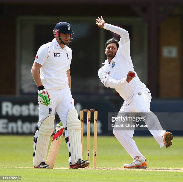 Ravi Rampaul of West Indies in action watched by Ian Bell of England Lions during day two of the tour match between England Lions and West Indies at...