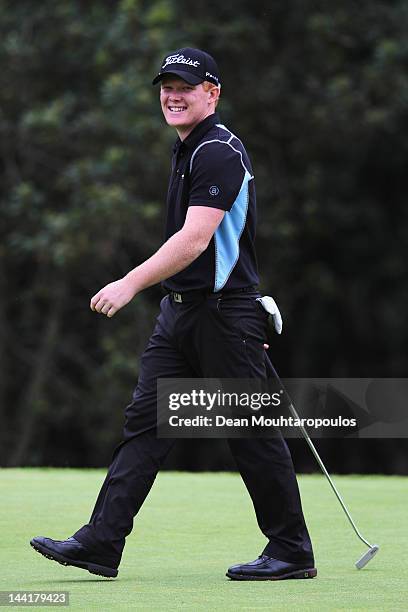 Chris Lloyd of England laughs after sink a long putt for birdie on the 13th green during Day Two of the Madeira Islands Open at Santo da Serra Golf...