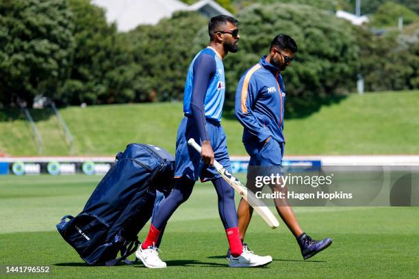 Hardik Pandya and Strength and Conditioning Coach Harsha A I look on during an India training session ahead of the New Zealand and India T20...