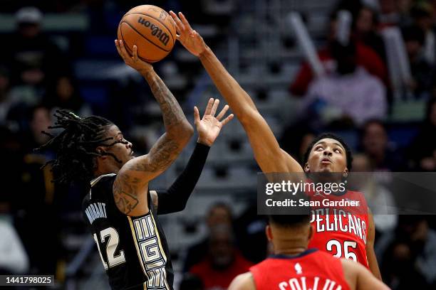 Ja Morant of the Memphis Grizzlies is blocked by Trey Murphy III of the New Orleans Pelicans during the third quarter of an NBA game at Smoothie King...