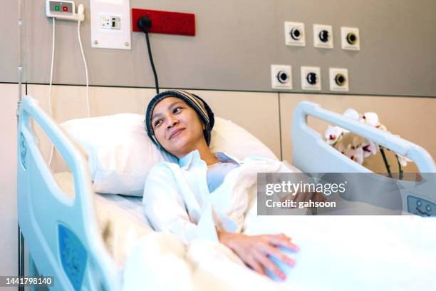 female atient lying in hospital bed - radiotherapy stock pictures, royalty-free photos & images