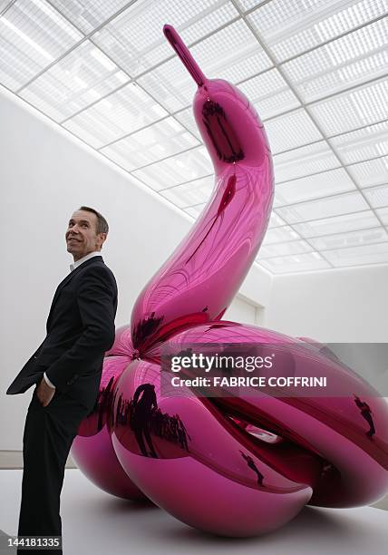 Artist Jeff Koons' poses next to "Balloon Swan " on May 11, 2012 during an exhibition preview at the Fondation Beyeler museum in Basel. The Fondation...